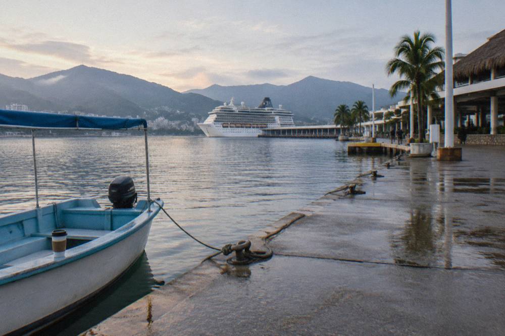 Empty marina docks in Puerto Vallarta under a calm morning sky before tour departures