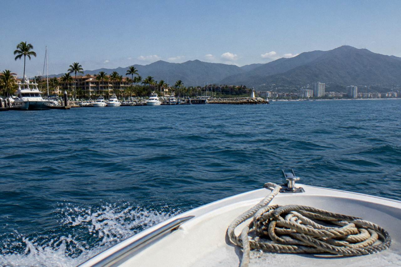 Open bow of a whale watching boat crossing the blue water of Banderas Bay under a clear morning sky