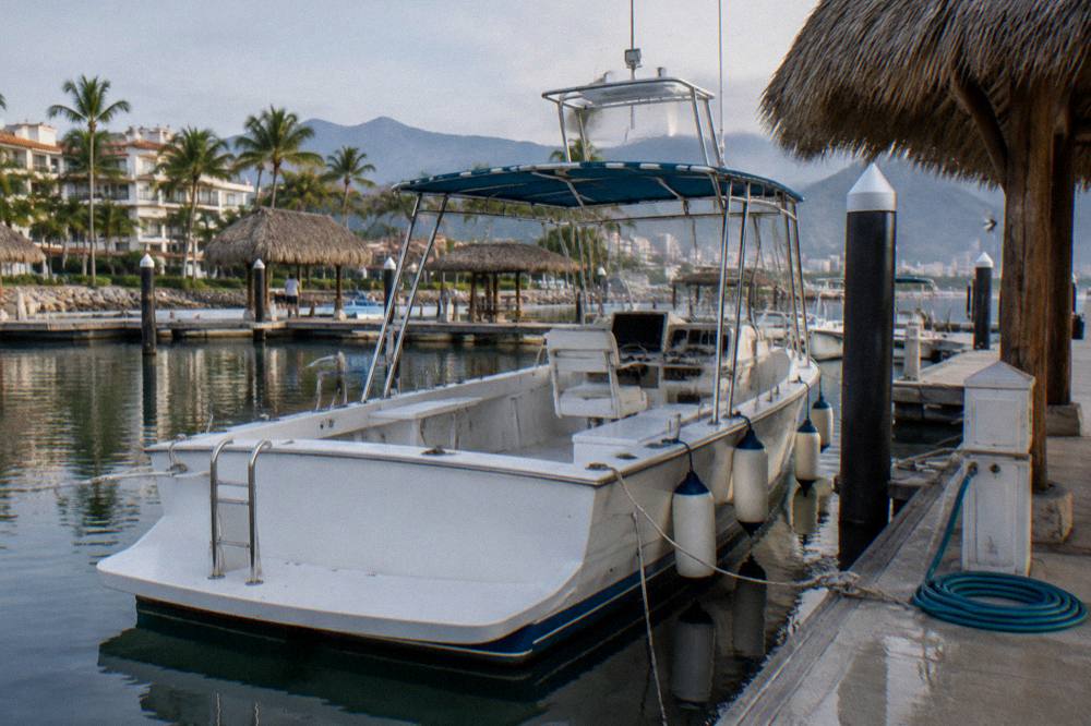 An empty whale watching boat moored at a marina dock in Banderas Bay before morning departures